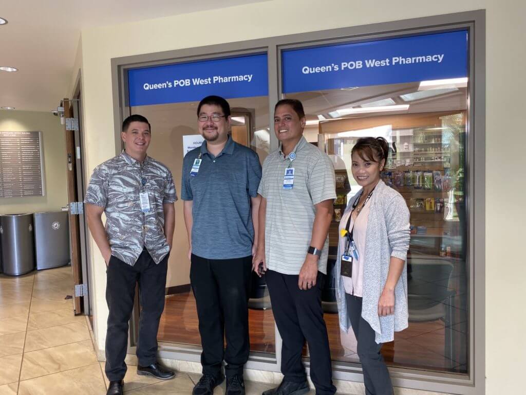 Staff standing in front of the pharmacy.