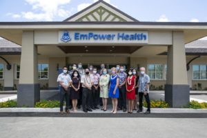 Staff with masks on standing in front of EmPower Health building