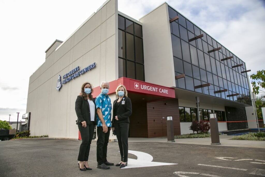 3 Hosptial leaders stand in front of Urgent Care center