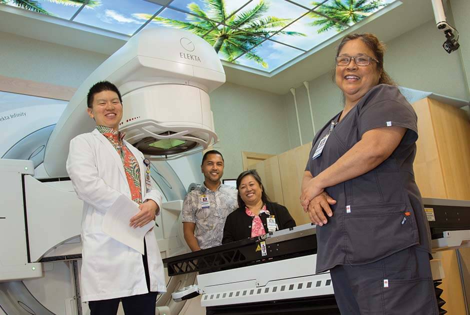 Radiation staff posing with scanner.
