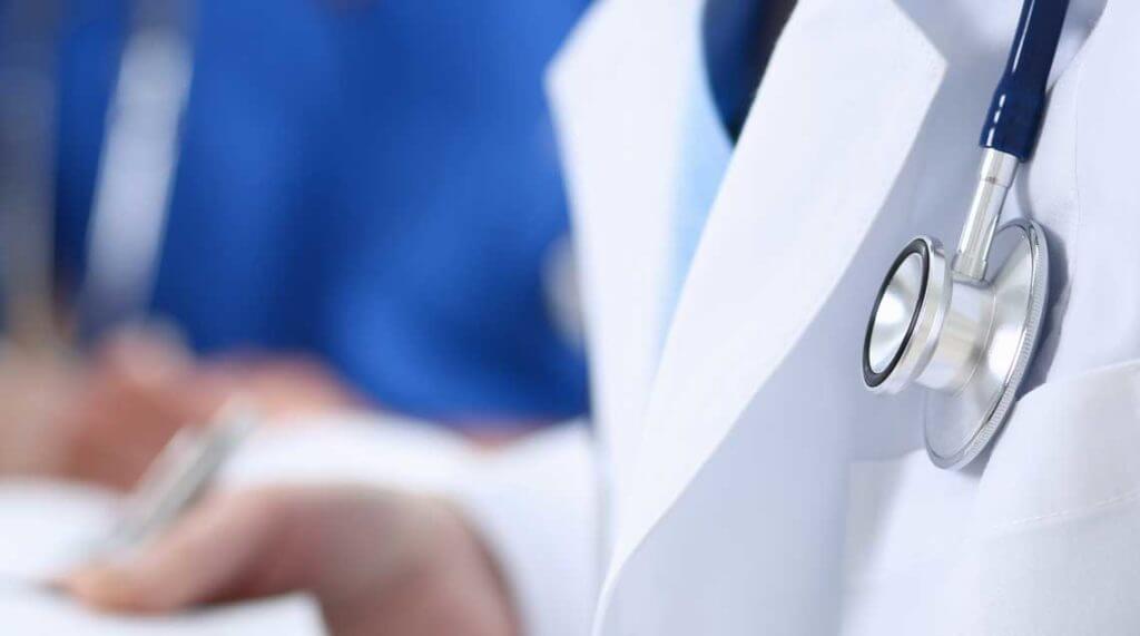 Close up of stethoscope on a Doctor's white coat.