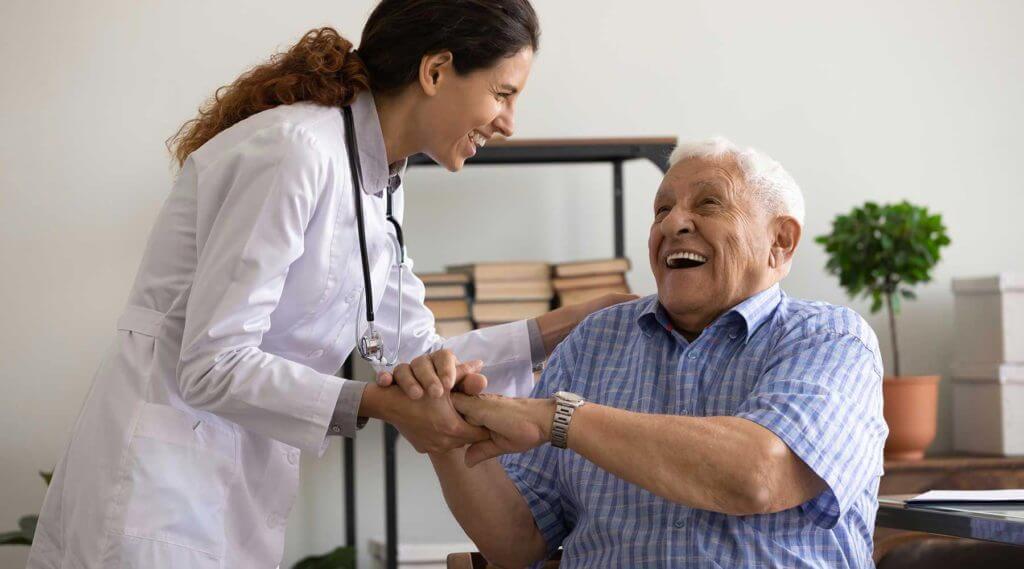 Female doctor laughing with senior male patient