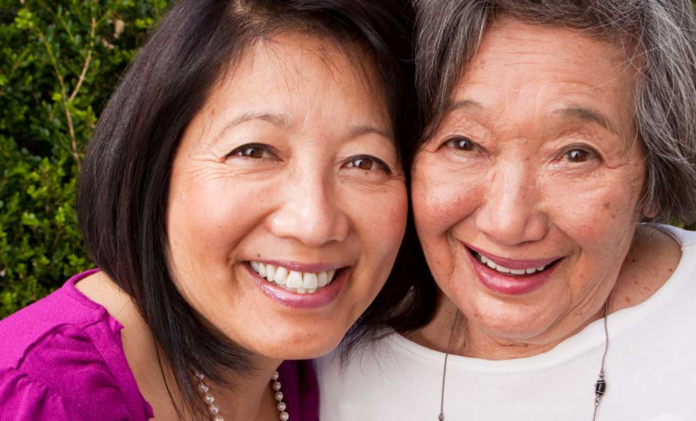 Senior woman and her daughter smiling together