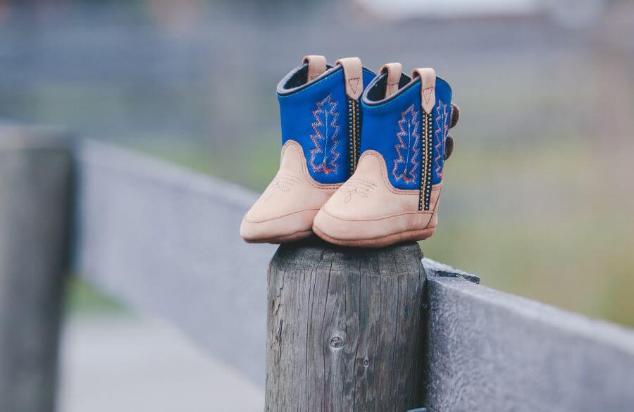Baby boots on fence