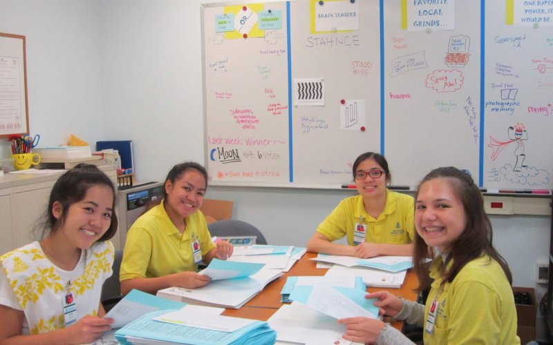 4 volunteers organizing paperwork
