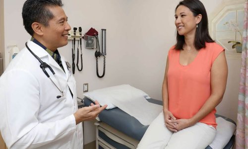 Physician talking with patient in exam room